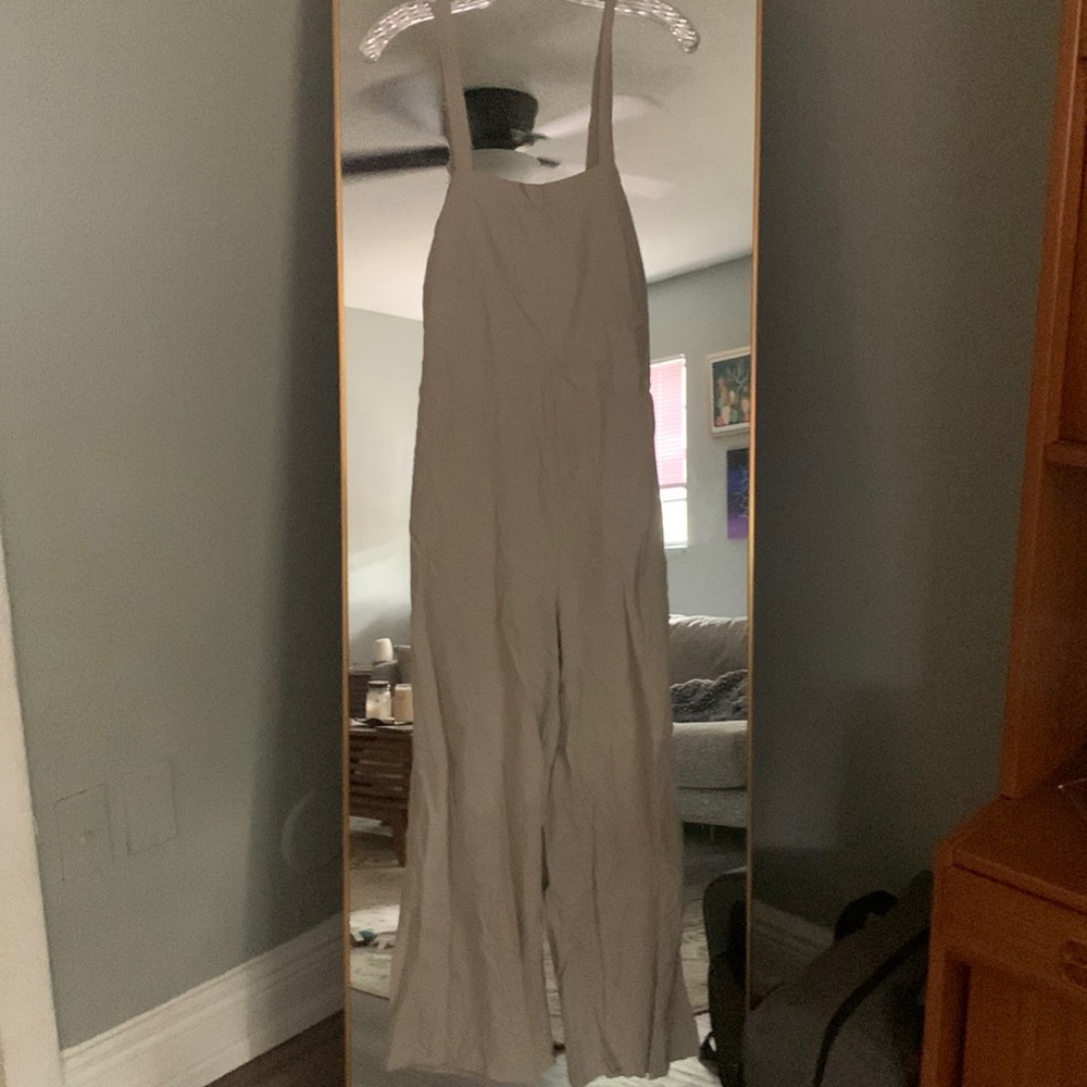 Cream colored ultra comfy jumpsuit that’s opened back and adjustable straps
